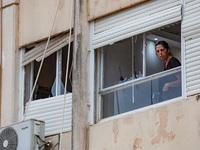 Residents and Israeli authorities inspect the damage following an overnight rocket attack from Lebanon in Haifa, Israel, on October 7, 2024....