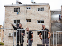 Residents and Israeli authorities inspect the damage following an overnight rocket attack from Lebanon in Haifa, Israel, on October 7, 2024....