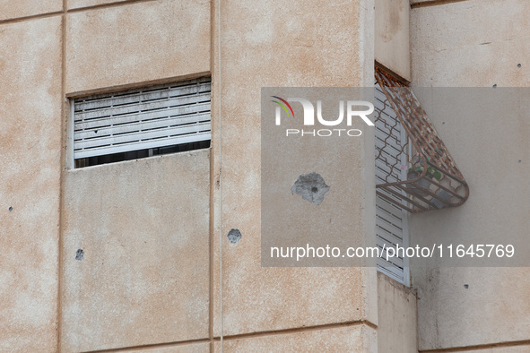 Residents and Israeli authorities inspect the damage following an overnight rocket attack from Lebanon in Haifa, Israel, on October 7, 2024....