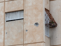 Residents and Israeli authorities inspect the damage following an overnight rocket attack from Lebanon in Haifa, Israel, on October 7, 2024....