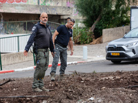 Residents and Israeli authorities inspect the damage following an overnight rocket attack from Lebanon in Haifa, Israel, on October 7, 2024....