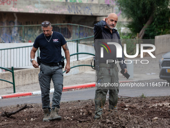 Residents and Israeli authorities inspect the damage following an overnight rocket attack from Lebanon in Haifa, Israel, on October 7, 2024....