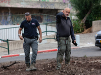 Residents and Israeli authorities inspect the damage following an overnight rocket attack from Lebanon in Haifa, Israel, on October 7, 2024....