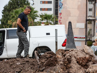 Residents and Israeli authorities inspect the damage following an overnight rocket attack from Lebanon in Haifa, Israel, on October 7, 2024....