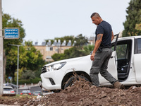 Residents and Israeli authorities inspect the damage following an overnight rocket attack from Lebanon in Haifa, Israel, on October 7, 2024....