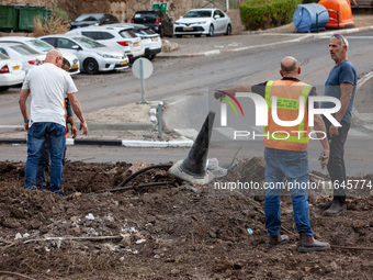 Residents and Israeli authorities inspect the damage following an overnight rocket attack from Lebanon in Haifa, Israel, on October 7, 2024....