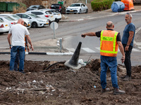 Residents and Israeli authorities inspect the damage following an overnight rocket attack from Lebanon in Haifa, Israel, on October 7, 2024....