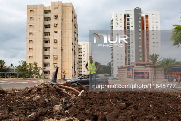 Residents and Israeli authorities inspect the damage following an overnight rocket attack from Lebanon in Haifa, Israel, on October 7, 2024....