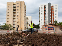 Residents and Israeli authorities inspect the damage following an overnight rocket attack from Lebanon in Haifa, Israel, on October 7, 2024....