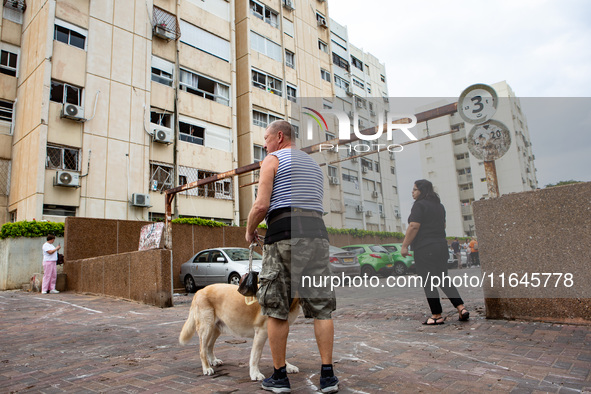 Residents and Israeli authorities inspect the damage following an overnight rocket attack from Lebanon in Haifa, Israel, on October 7, 2024....