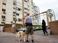 Residents and Israeli authorities inspect the damage following an overnight rocket attack from Lebanon in Haifa, Israel, on October 7, 2024....