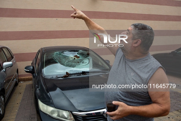 Residents and Israeli authorities inspect the damage following an overnight rocket attack from Lebanon in Haifa, Israel, on October 7, 2024....