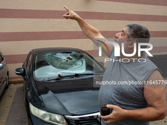 Residents and Israeli authorities inspect the damage following an overnight rocket attack from Lebanon in Haifa, Israel, on October 7, 2024....