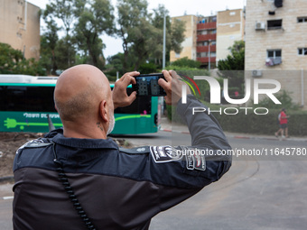 Residents and Israeli authorities inspect the damage following an overnight rocket attack from Lebanon in Haifa, Israel, on October 7, 2024....