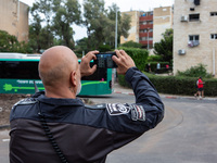 Residents and Israeli authorities inspect the damage following an overnight rocket attack from Lebanon in Haifa, Israel, on October 7, 2024....