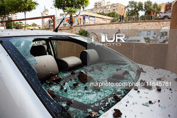 Residents and Israeli authorities inspect the damage following an overnight rocket attack from Lebanon in Haifa, Israel, on October 7, 2024....