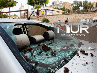 Residents and Israeli authorities inspect the damage following an overnight rocket attack from Lebanon in Haifa, Israel, on October 7, 2024....