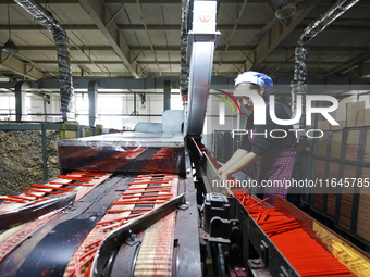 A worker produces pencils at the production workshop of China First Pencil Sihong Co., LTD in Sihong Economic Development Zone in Suqian, Ji...