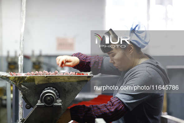 A worker produces pencils at the production workshop of China First Pencil Sihong Co., LTD in Sihong Economic Development Zone in Suqian, Ji...