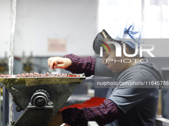 A worker produces pencils at the production workshop of China First Pencil Sihong Co., LTD in Sihong Economic Development Zone in Suqian, Ji...