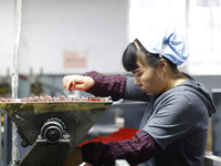 A worker produces pencils at the production workshop of China First Pencil Sihong Co., LTD in Sihong Economic Development Zone in Suqian, Ji...