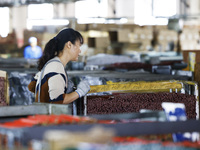 A worker produces pencils at the production workshop of China First Pencil Sihong Co., LTD in Sihong Economic Development Zone in Suqian, Ji...