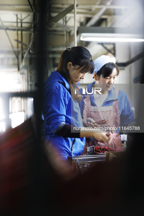 A worker produces pencils at the production workshop of China First Pencil Sihong Co., LTD in Sihong Economic Development Zone in Suqian, Ji...