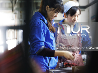 A worker produces pencils at the production workshop of China First Pencil Sihong Co., LTD in Sihong Economic Development Zone in Suqian, Ji...