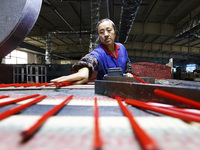 A worker produces pencils at the production workshop of China First Pencil Sihong Co., LTD in Sihong Economic Development Zone in Suqian, Ji...