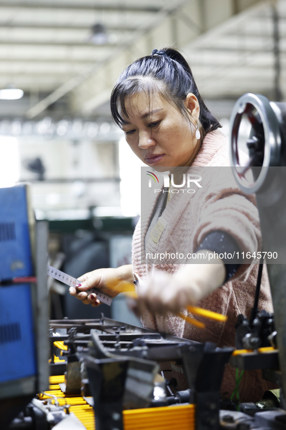 A worker produces pencils at the production workshop of China First Pencil Sihong Co., LTD in Sihong Economic Development Zone in Suqian, Ji...