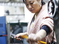 A worker produces pencils at the production workshop of China First Pencil Sihong Co., LTD in Sihong Economic Development Zone in Suqian, Ji...