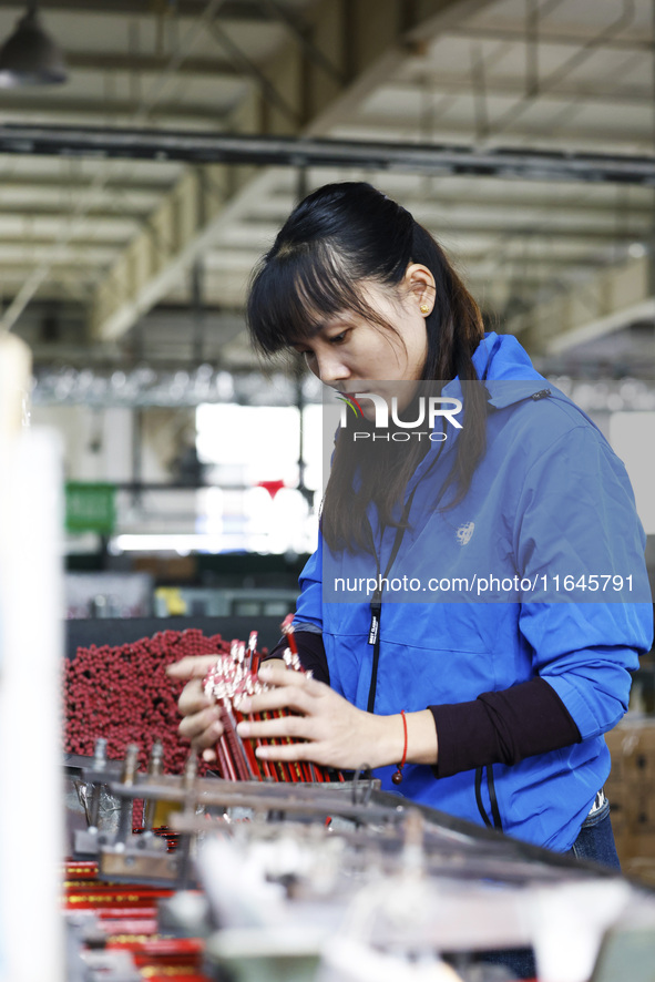 A worker produces pencils at the production workshop of China First Pencil Sihong Co., LTD in Sihong Economic Development Zone in Suqian, Ji...