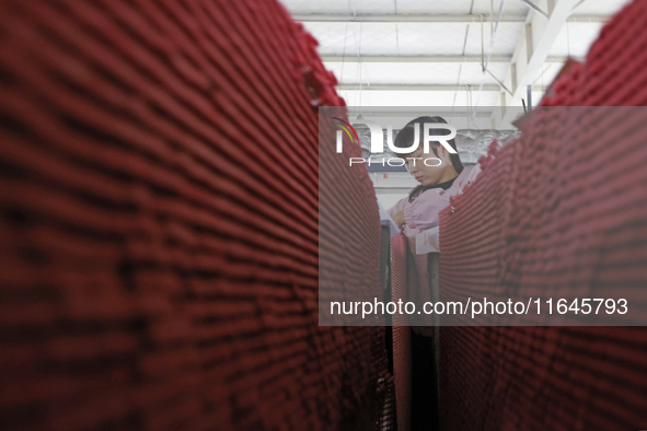 A worker produces pencils at the production workshop of China First Pencil Sihong Co., LTD in Sihong Economic Development Zone in Suqian, Ji...