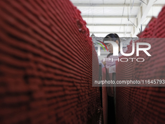 A worker produces pencils at the production workshop of China First Pencil Sihong Co., LTD in Sihong Economic Development Zone in Suqian, Ji...