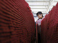 A worker produces pencils at the production workshop of China First Pencil Sihong Co., LTD in Sihong Economic Development Zone in Suqian, Ji...