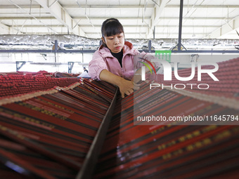 A worker produces pencils at the production workshop of China First Pencil Sihong Co., LTD in Sihong Economic Development Zone in Suqian, Ji...