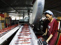 A worker produces pencils at the production workshop of China First Pencil Sihong Co., LTD in Sihong Economic Development Zone in Suqian, Ji...