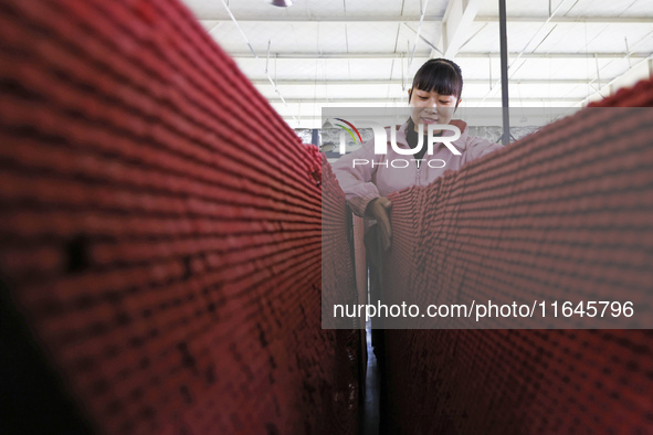 A worker produces pencils at the production workshop of China First Pencil Sihong Co., LTD in Sihong Economic Development Zone in Suqian, Ji...