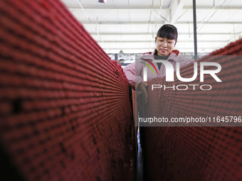 A worker produces pencils at the production workshop of China First Pencil Sihong Co., LTD in Sihong Economic Development Zone in Suqian, Ji...