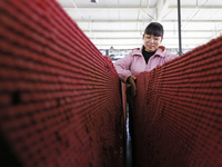 A worker produces pencils at the production workshop of China First Pencil Sihong Co., LTD in Sihong Economic Development Zone in Suqian, Ji...