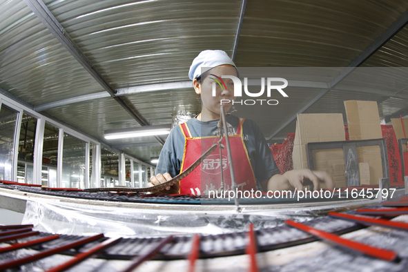 A worker produces pencils at the production workshop of China First Pencil Sihong Co., LTD in Sihong Economic Development Zone in Suqian, Ji...