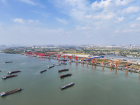 Cranes carry out loading and unloading operations in an orderly manner at the Yaowan Comprehensive Terminal in Nanchang, China, on October 6...