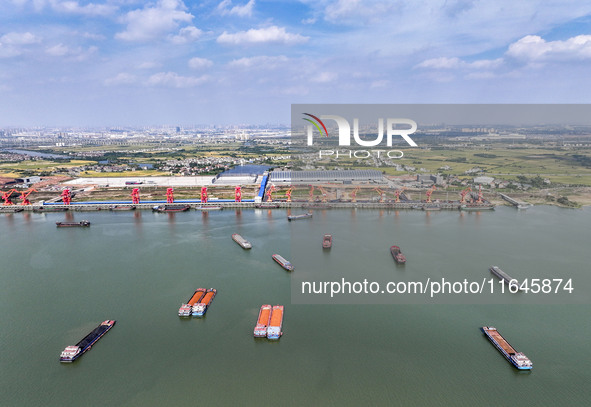 Cranes carry out loading and unloading operations in an orderly manner at the Yaowan Comprehensive Terminal in Nanchang, China, on October 6...