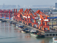 Cranes carry out loading and unloading operations in an orderly manner at the Yaowan Comprehensive Terminal in Nanchang, China, on October 6...