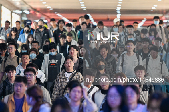 Passengers exit Nanjing Railway Station in Nanjing, China, on October 7, 2024. 