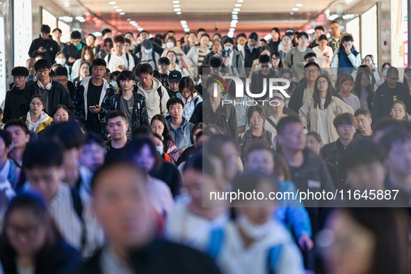 Passengers exit Nanjing Railway Station in Nanjing, China, on October 7, 2024. 