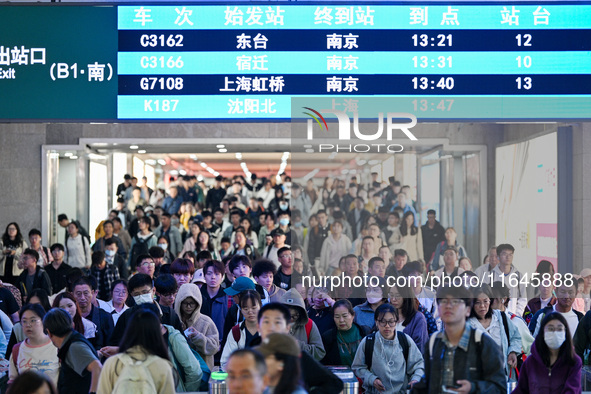 Passengers exit Nanjing Railway Station in Nanjing, China, on October 7, 2024. 