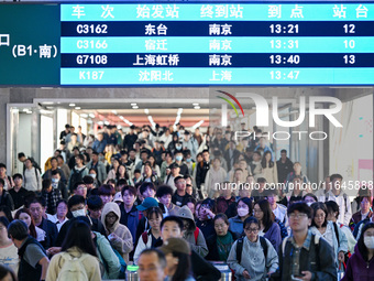 Passengers exit Nanjing Railway Station in Nanjing, China, on October 7, 2024. (