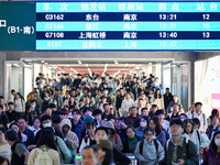 Passengers exit Nanjing Railway Station in Nanjing, China, on October 7, 2024. (