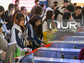 Passengers exit Nanjing Railway Station in Nanjing, China, on October 7, 2024. (